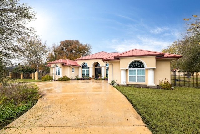 mediterranean / spanish house with a front lawn