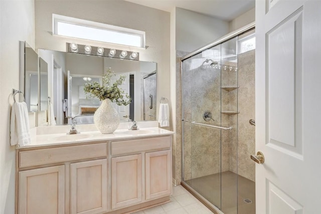 bathroom featuring a shower with door, vanity, and tile patterned flooring