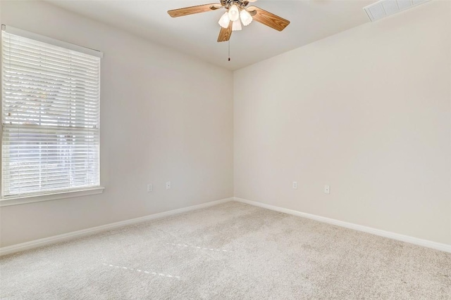 spare room featuring carpet and ceiling fan