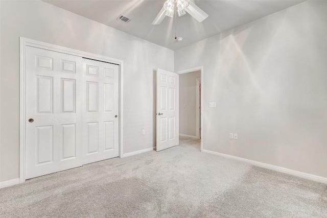 unfurnished bedroom featuring a closet, ceiling fan, and light colored carpet