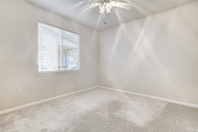 unfurnished room with ceiling fan, carpet floors, and a wealth of natural light