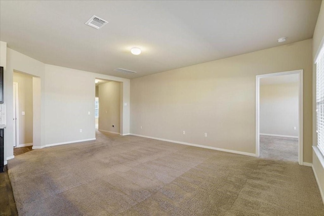 unfurnished room featuring light carpet