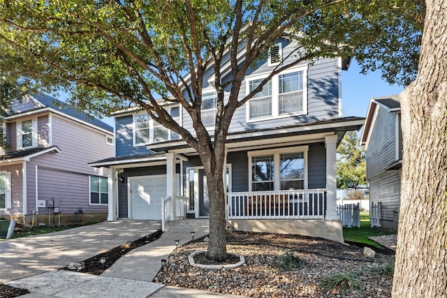 front of property featuring covered porch and a garage