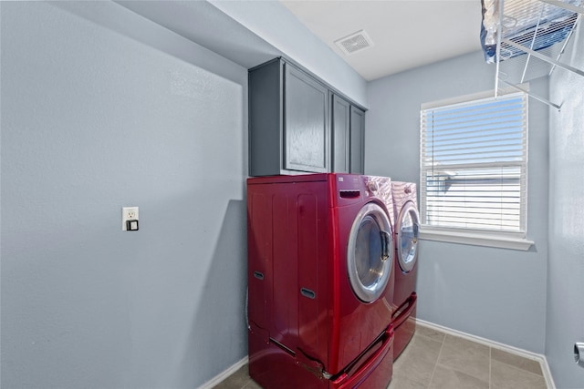 clothes washing area with cabinets and independent washer and dryer