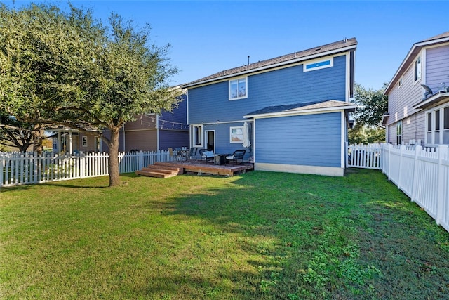 rear view of property with a lawn and a wooden deck