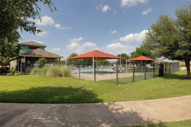 view of swimming pool with a yard