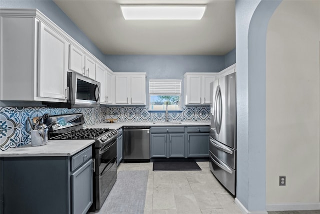 kitchen with gray cabinetry, sink, white cabinetry, and stainless steel appliances