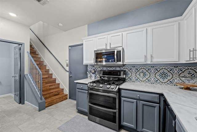 kitchen with decorative backsplash, white cabinetry, gray cabinets, and appliances with stainless steel finishes