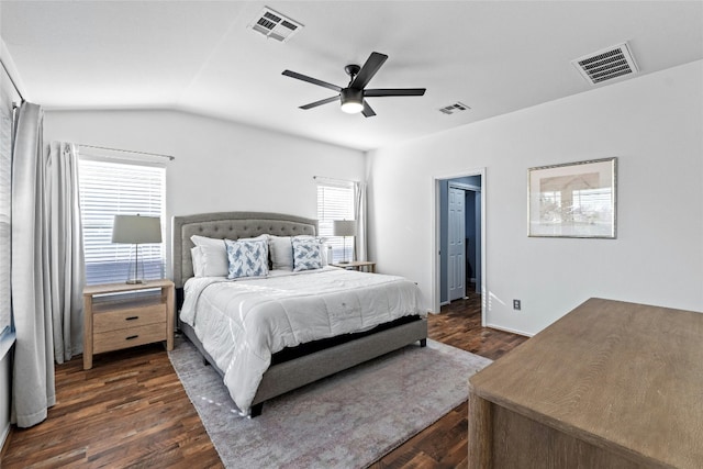 bedroom with ceiling fan, dark wood-type flooring, and vaulted ceiling