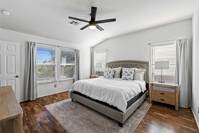 bedroom with dark hardwood / wood-style flooring, vaulted ceiling, and ceiling fan