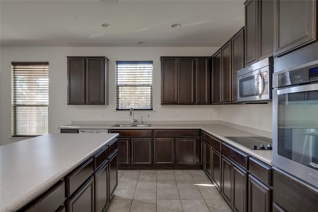 kitchen with light tile patterned flooring, sink, a healthy amount of sunlight, and stainless steel appliances