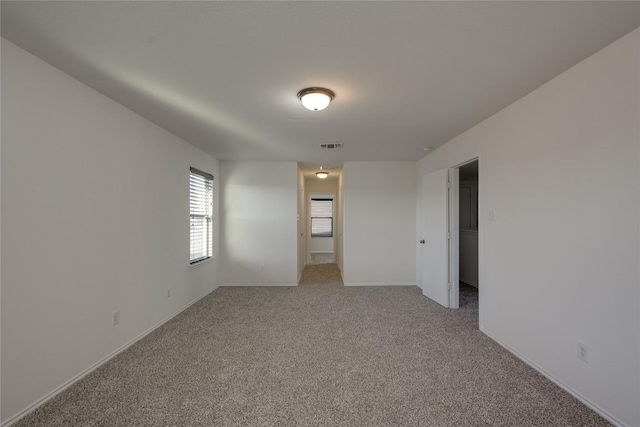 unfurnished room with light colored carpet