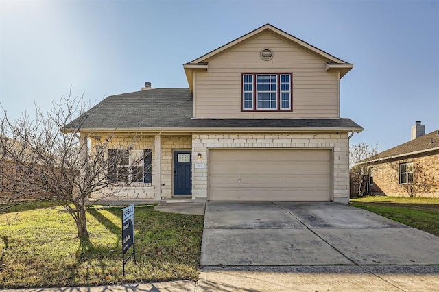 view of front property featuring a garage and a front lawn