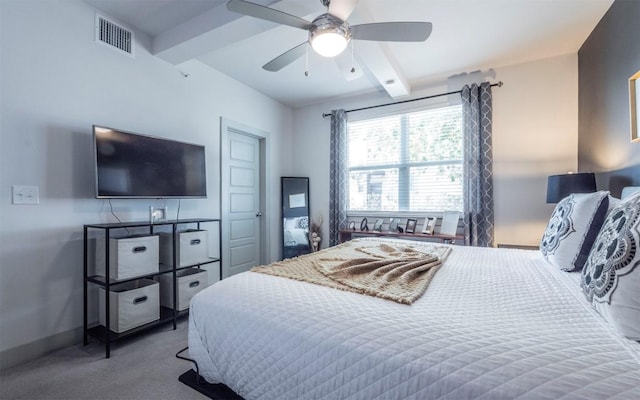 bedroom featuring beamed ceiling, ceiling fan, and carpet