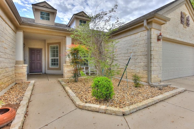 view of exterior entry featuring a garage