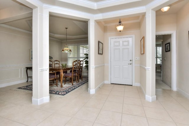 foyer featuring ornamental molding and light tile patterned flooring