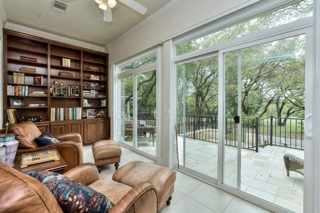 interior space featuring crown molding, light tile patterned floors, and ceiling fan