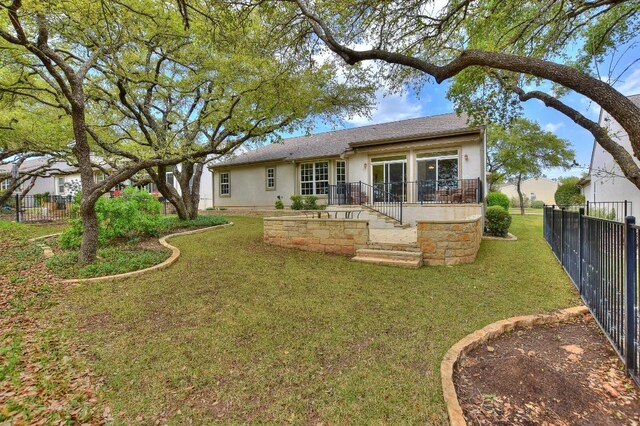 rear view of property with a yard