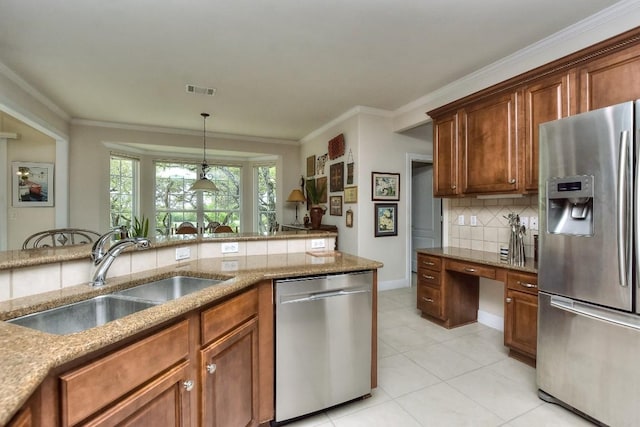 kitchen with backsplash, ornamental molding, stainless steel appliances, sink, and hanging light fixtures