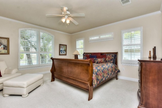 carpeted bedroom with ceiling fan and crown molding