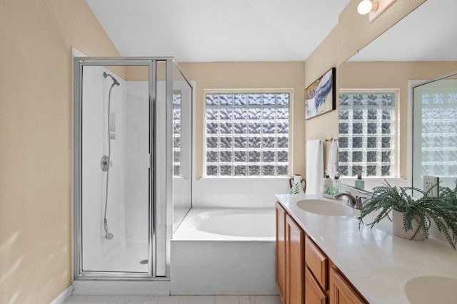 bathroom featuring vanity and independent shower and bath