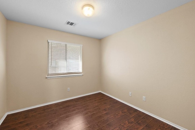 spare room featuring dark hardwood / wood-style flooring