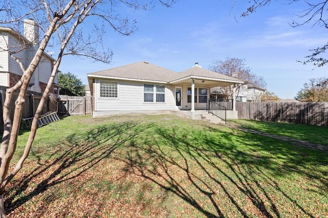 rear view of property with a yard and a patio