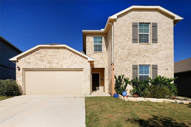 view of front facade featuring a front yard and a garage