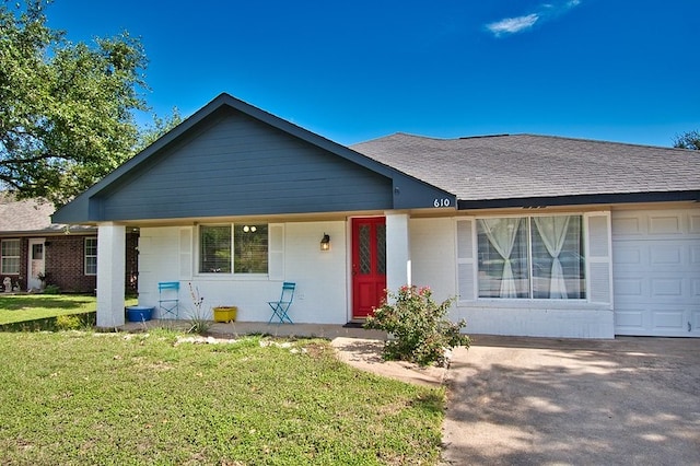 single story home featuring a front yard, a porch, and a garage