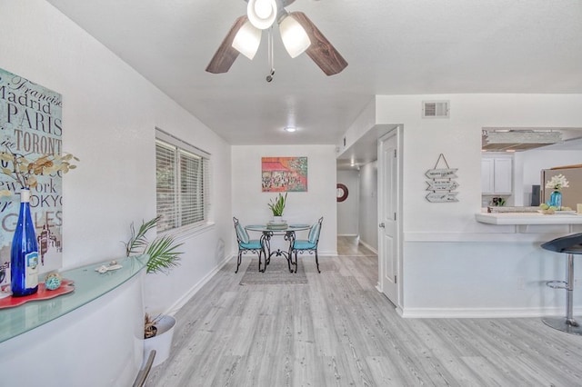 dining space featuring light hardwood / wood-style flooring and ceiling fan