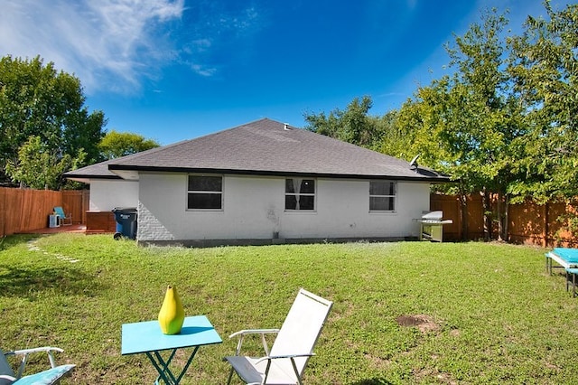 rear view of house with a lawn