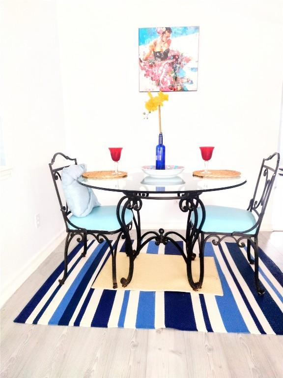 dining space featuring wood-type flooring