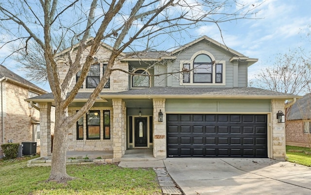 view of front facade featuring central AC, a front yard, and a garage