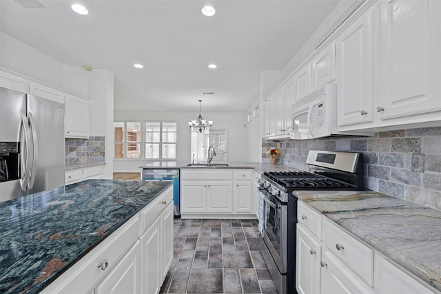 kitchen featuring stone counters, white cabinetry, and stainless steel appliances