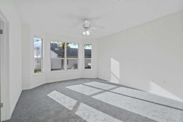 unfurnished room featuring dark carpet and ceiling fan