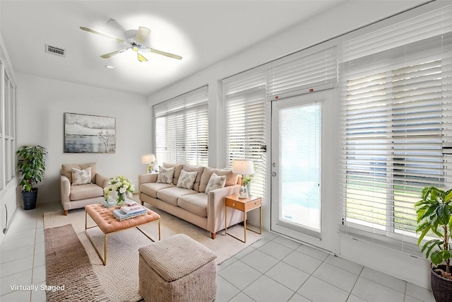 living room with ceiling fan and light tile patterned flooring