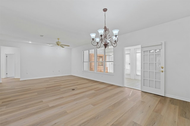 interior space featuring light hardwood / wood-style floors and ceiling fan with notable chandelier