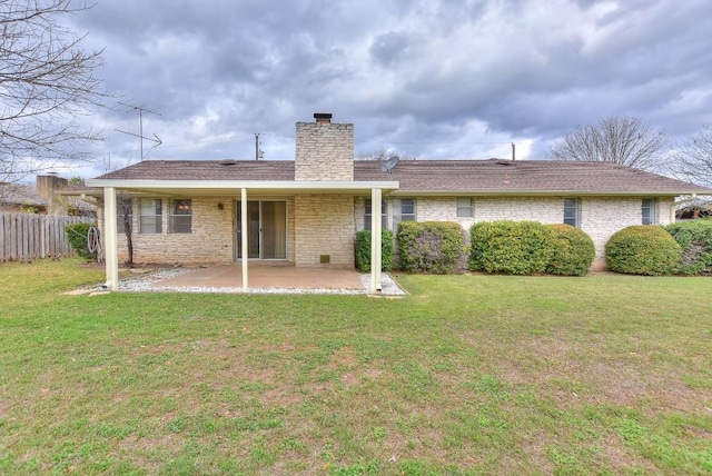 back of property featuring a lawn and a patio area