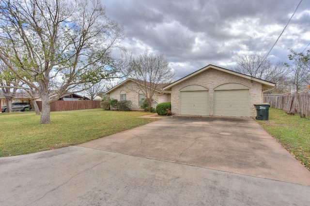 single story home with a garage and a front lawn