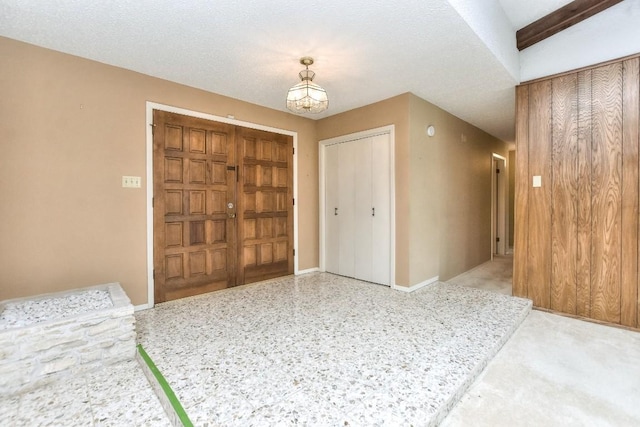 foyer entrance featuring a textured ceiling