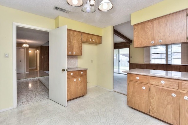 kitchen featuring decorative backsplash and a textured ceiling