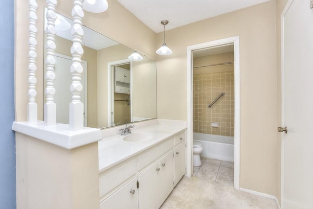 full bathroom featuring tile patterned floors, vanity, tiled shower / bath combo, and toilet