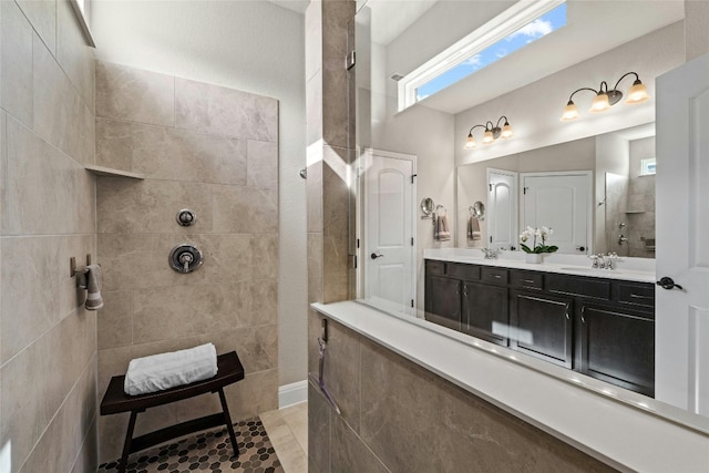 bathroom with a walk in shower, double vanity, and a sink