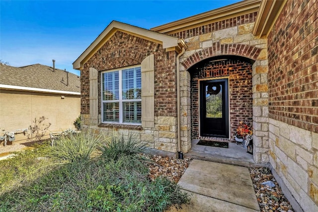 entrance to property with stone siding and brick siding