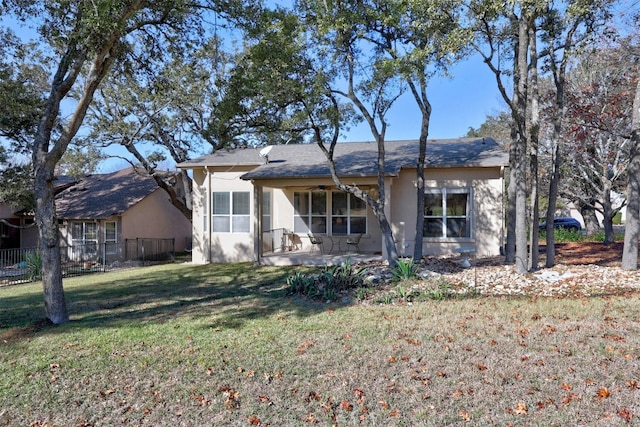 back of property featuring a yard and a patio