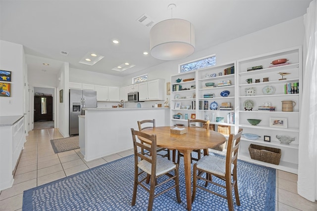 dining room with light tile patterned floors and built in features