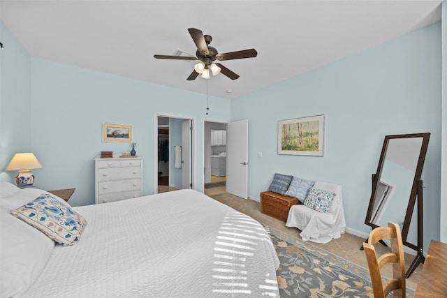 carpeted bedroom with ceiling fan and washer / dryer