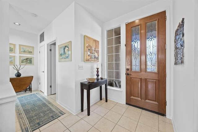 foyer entrance with light tile patterned floors