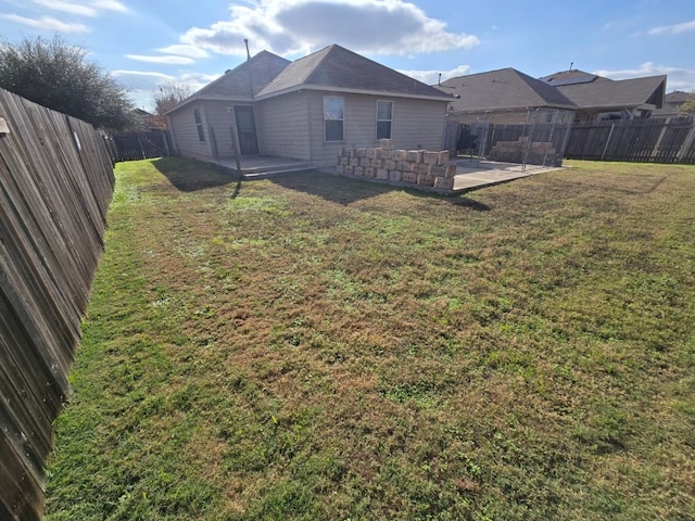 rear view of house with a lawn and a patio area