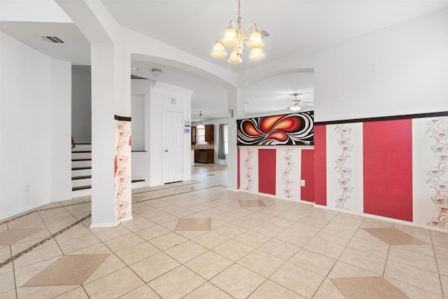 foyer entrance with ceiling fan with notable chandelier and light tile patterned floors